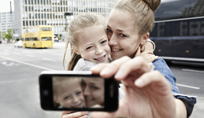 a mother and her daughter taking photos