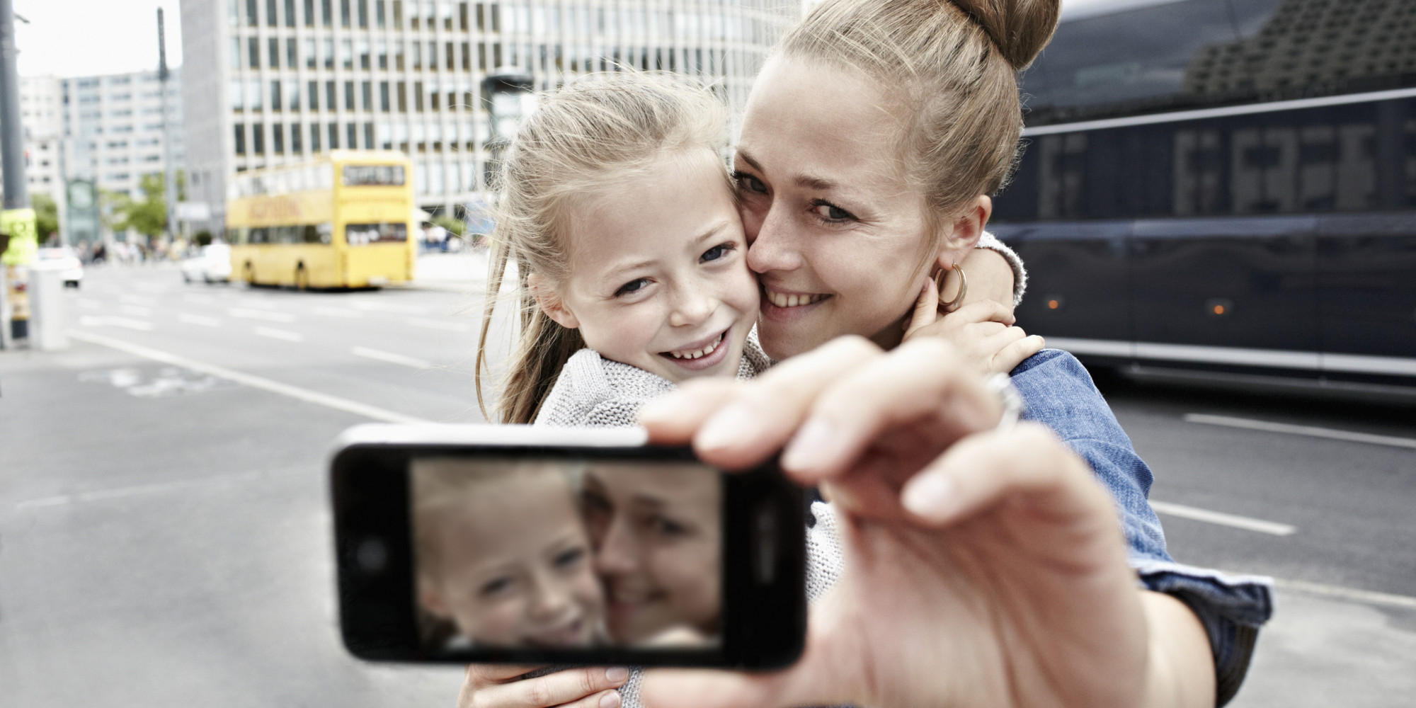 a mother and her daughter taking photos