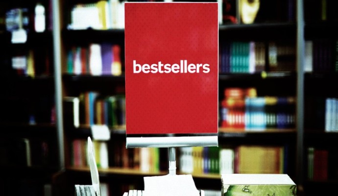Bestsellers area in bookstore - many books in the background.