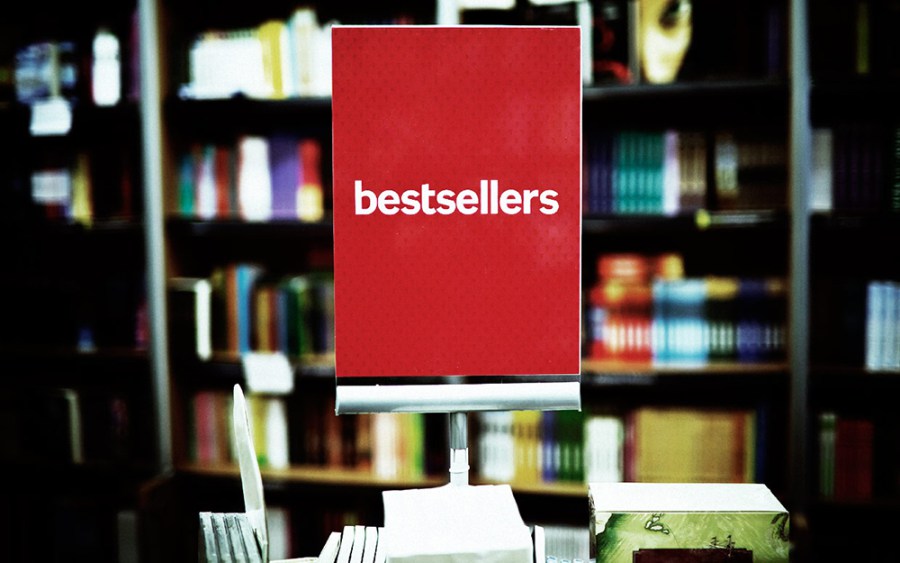 Bestsellers area in bookstore - many books in the background.