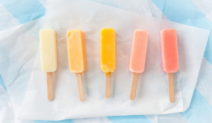 Homemade vanilla and strawberry ice cream popsicles