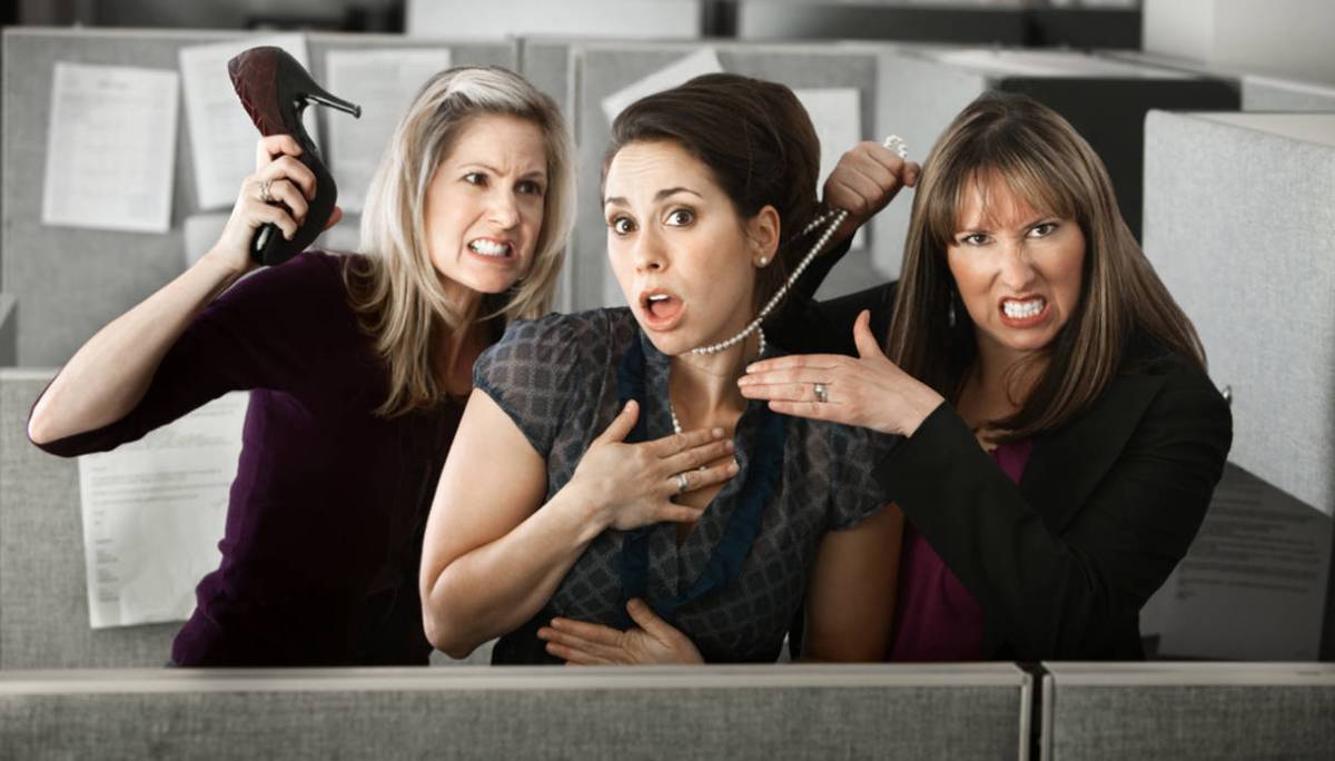 Three women office workers quarrels in cubicle